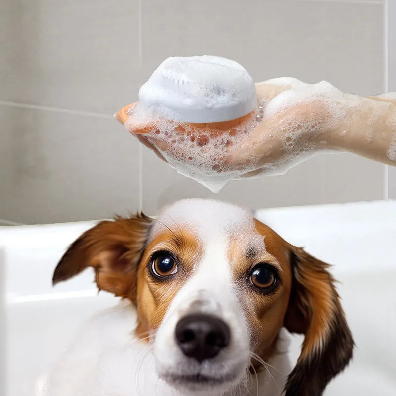 Orange silicone dog bath brush with shampoo dispenser and soft TPR bristles for pet grooming