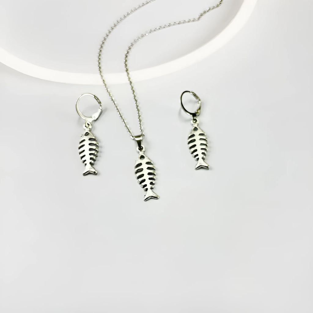 Fishbone pendant necklace and matching earrings set with adjustable chain on retro background