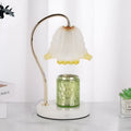 Candle light log aromatherapy table lamp with glass lampshade on nightstand, two bulbs lit, natural wood base