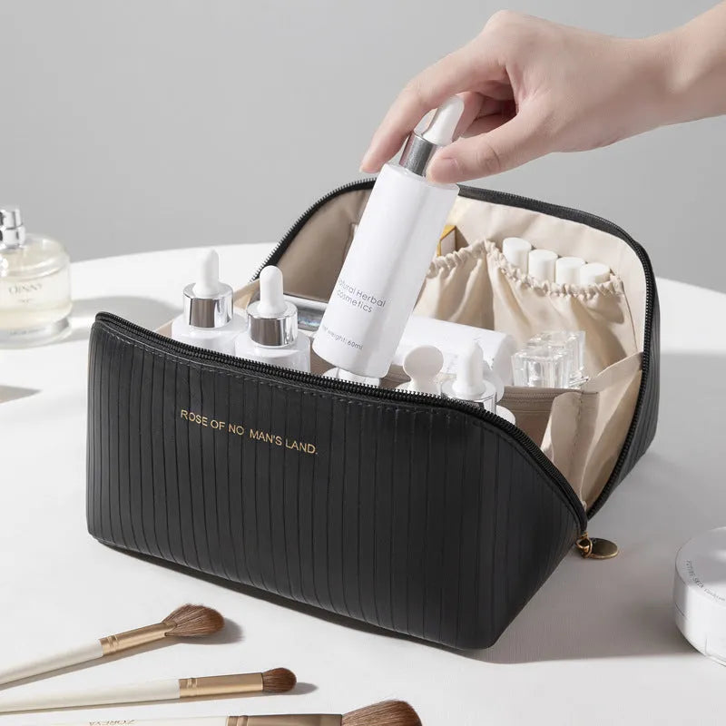 Vertical pattern pillow-shaped cubic makeup bag in PU material for women's travel storage.