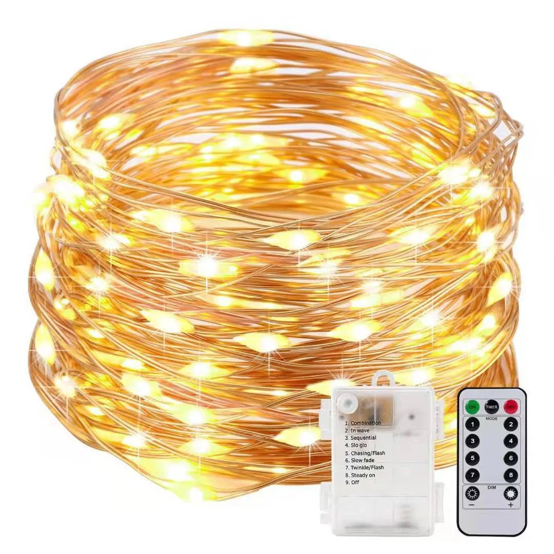 Close-up of flexible copper wire string light with 120 tiny LED bulbs, shaped in a spiral next to the battery control box.