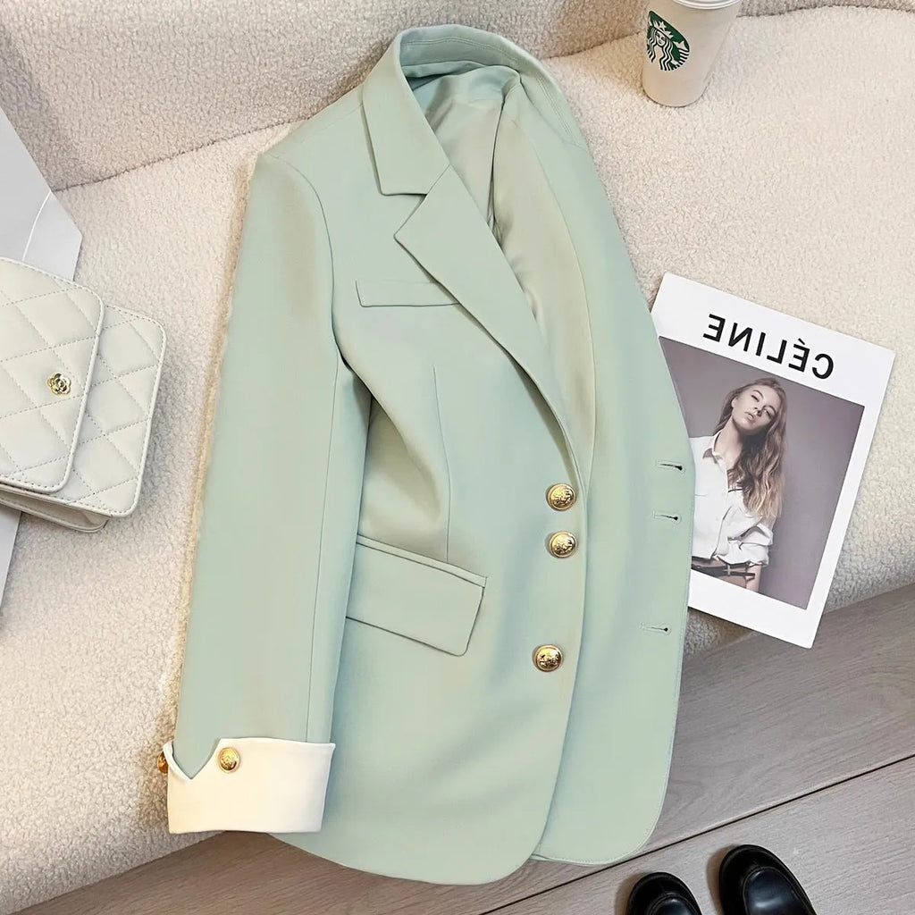 Korean-style loose fit women's coat in milky white, showing long sleeves and pockets.