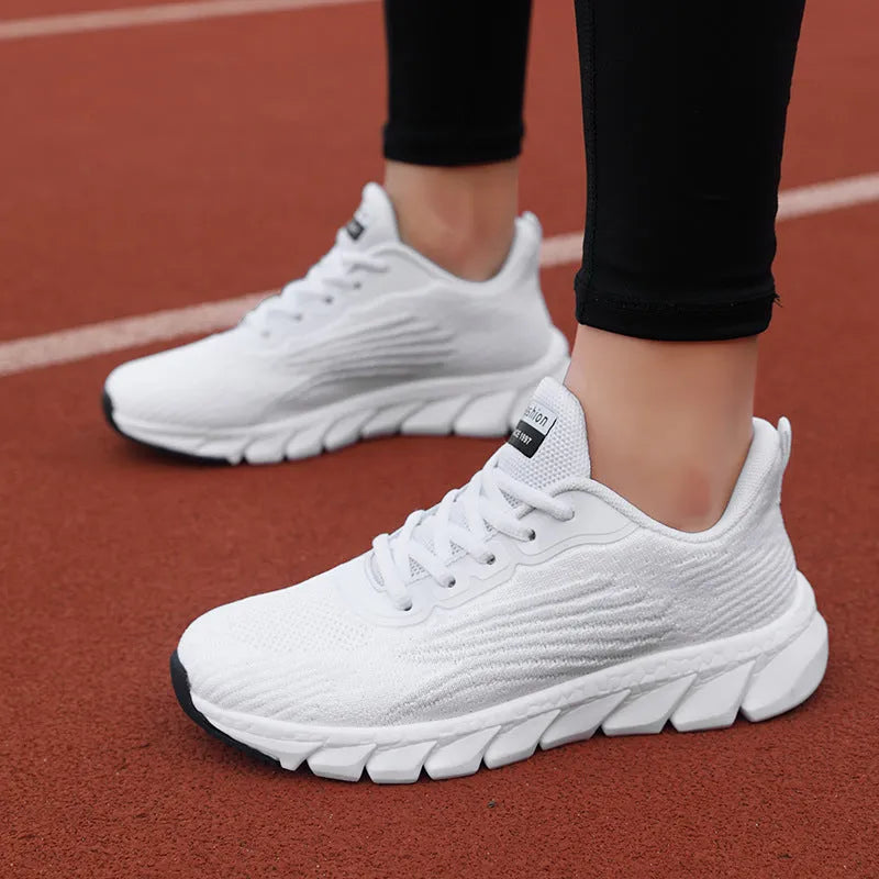Women's low-top black and white casual running sneakers with MD sole and cross-strap detail.