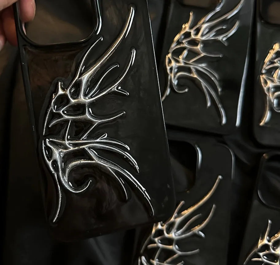 Black iPhone case with a blurred, three-dimensional wings design on the back.