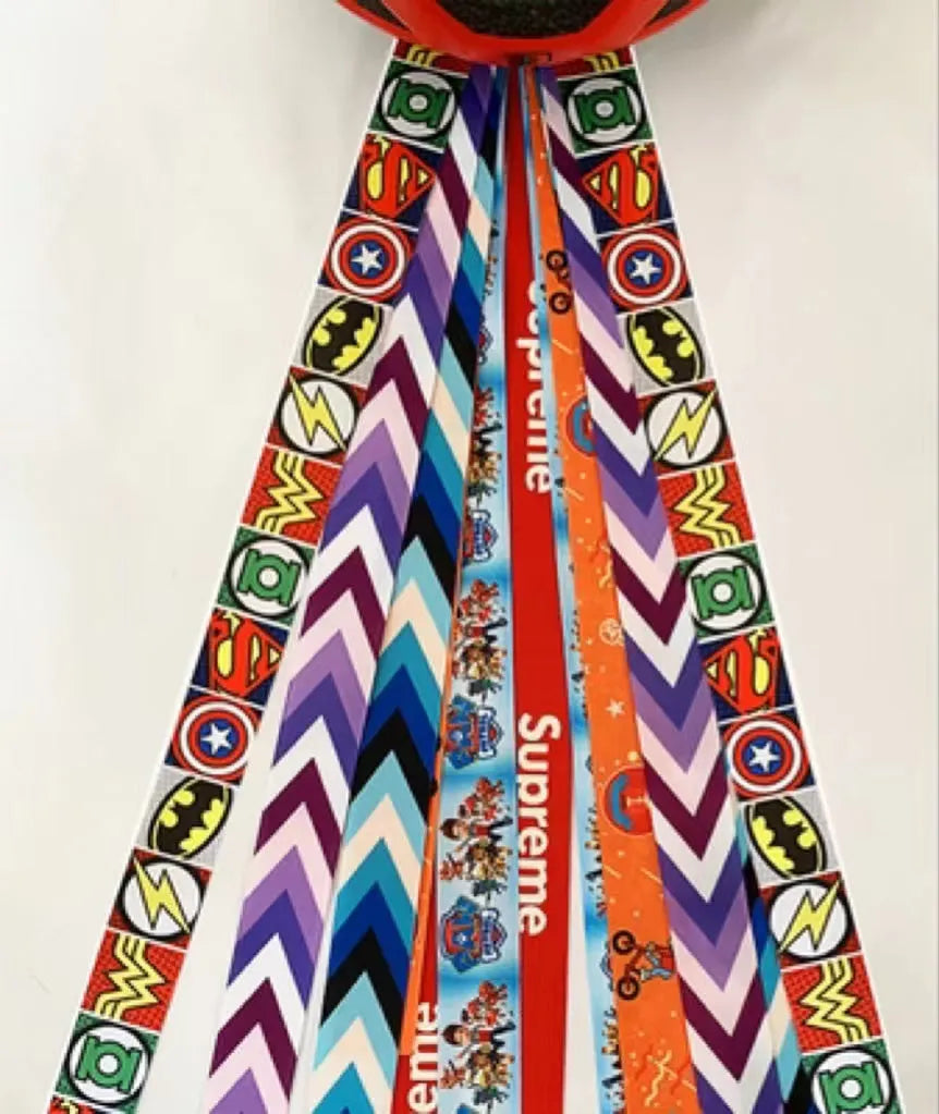A decorative ribbon streamer for attaching to a child's roller skate or ski helmet, shown in a selection of colours.