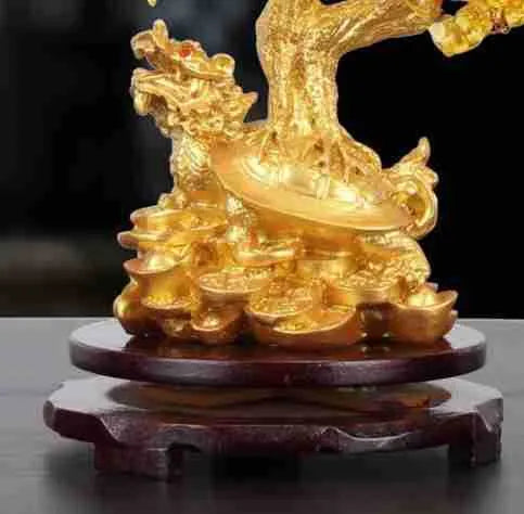 Citrine-coloured resin Feng Shui ornament of a small water turtle money tree on a white background.