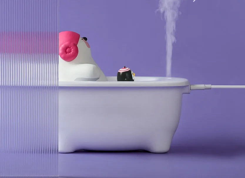 White USB-powered desktop air humidifier with large water tank on a desk.