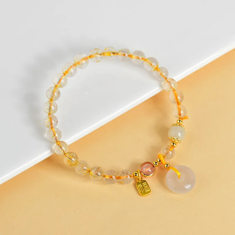 Gold rutilated quartz crystal bracelet with geometric design and safety buckle