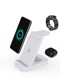 Black and white 3-in-1 wireless charging station for phone, AirPods and Apple Watch on a desk.