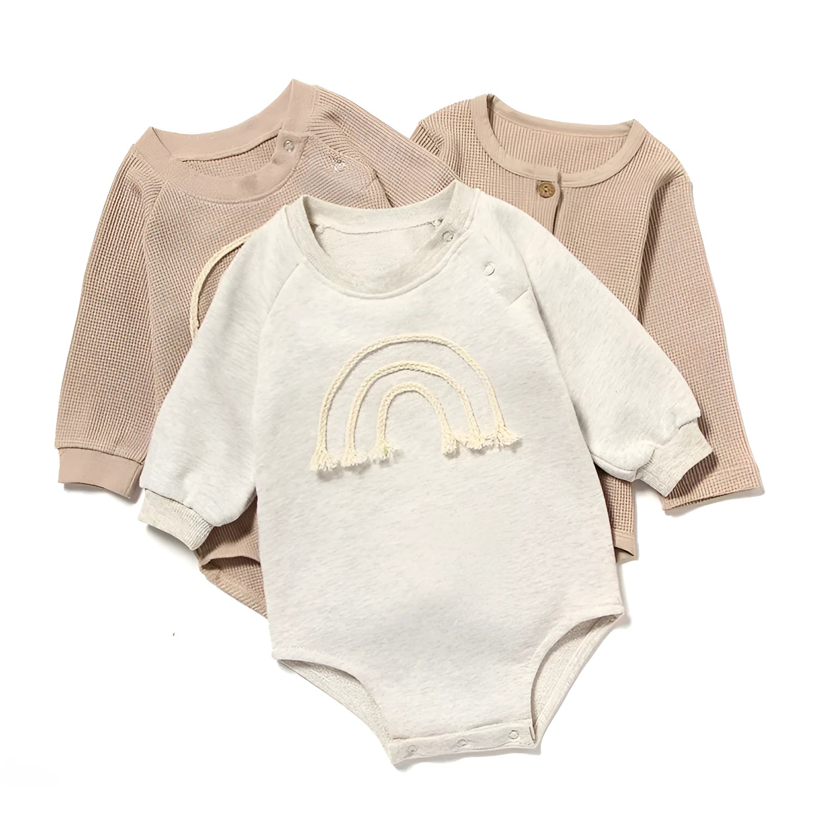 Baby wearing a beige waffle cotton long sleeve romper with rope ties, showing the triangle climbing style.