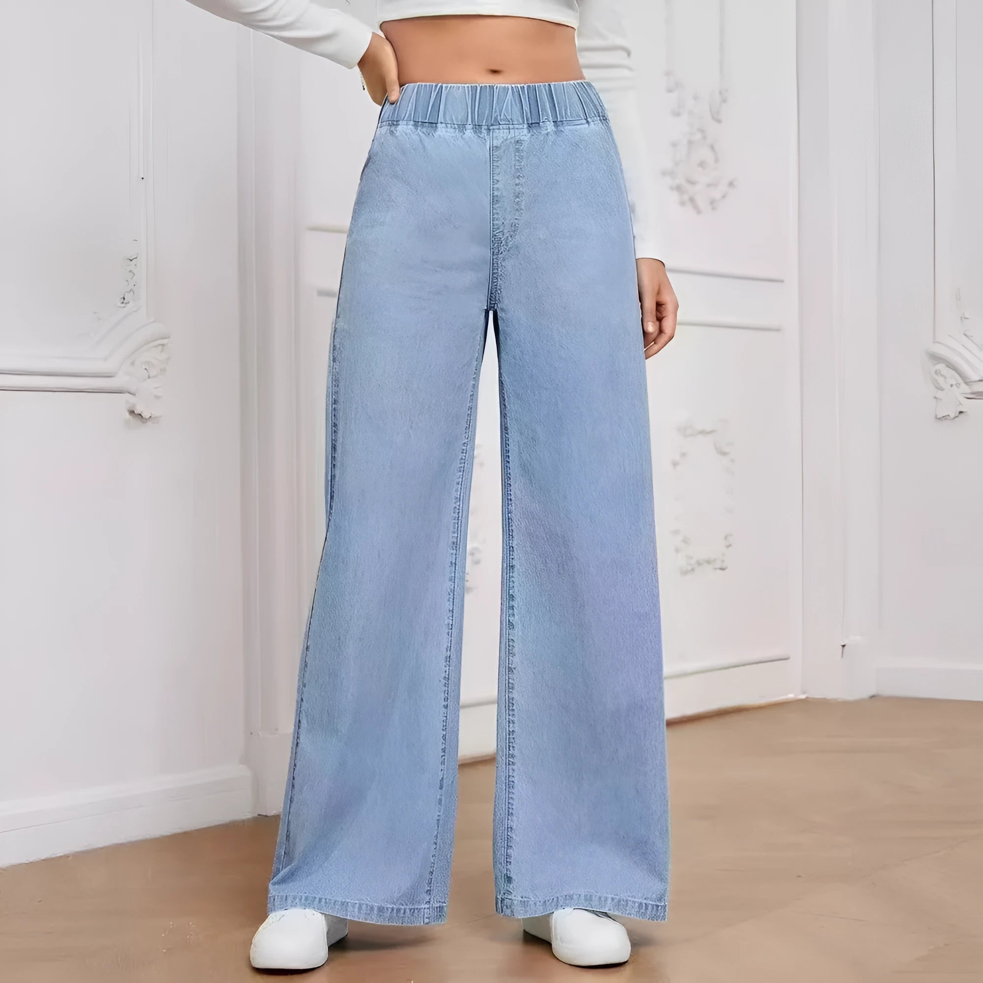 Light blue washed wide-leg denim trousers on a hanger, showing straight cut and mid-rise waist.