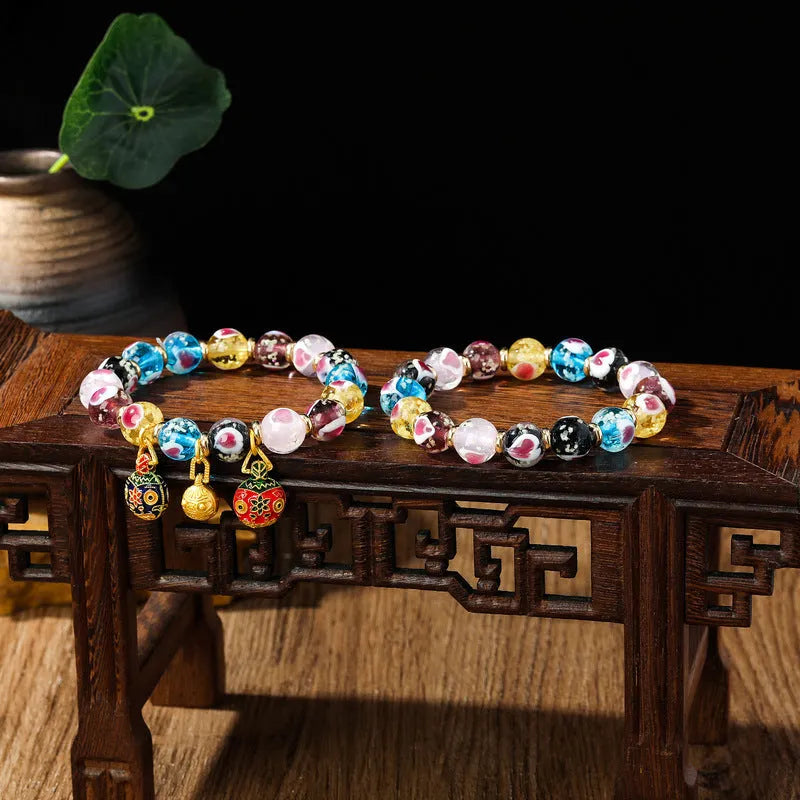 Handmade glass bracelet with swallowing gold beast design on heart-shaped 10mm beads