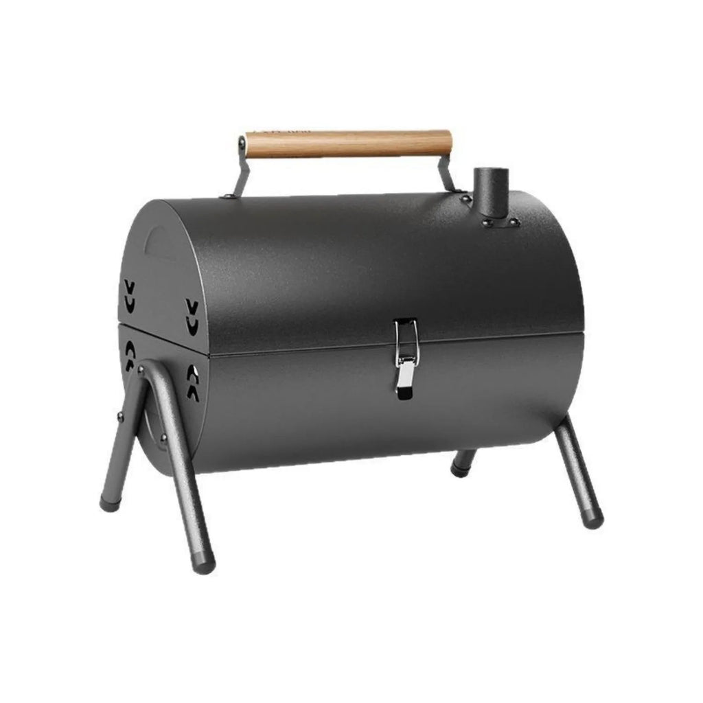 White round portable folding chimney grill with two carbon tanks and mesh grills on grass
