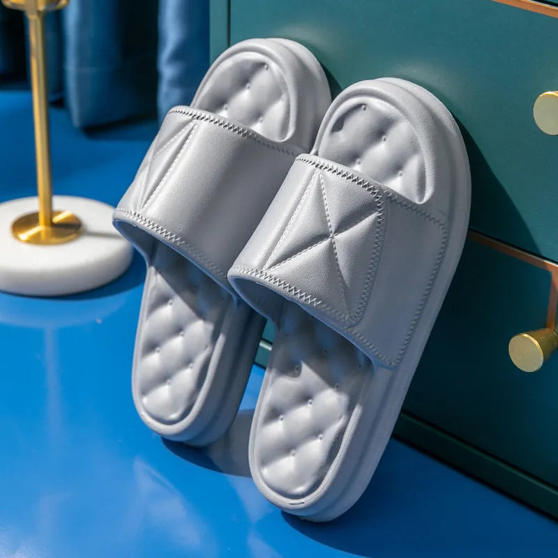 A pair of soft EVA bathroom slippers with a thick sole, shown in a choice of colours including black, caramel, green, pink, and yellow.