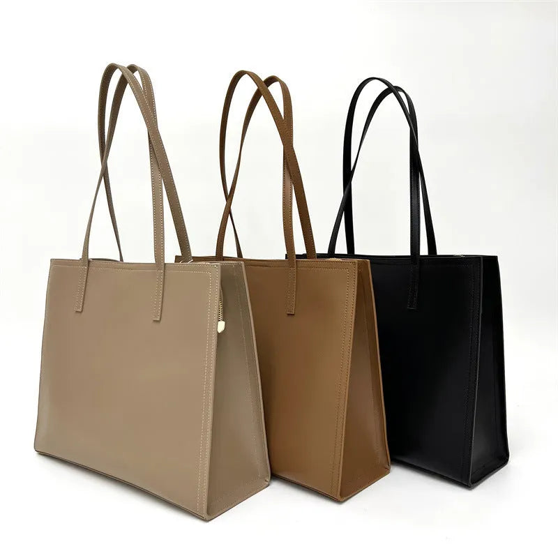 Women's brown genuine leather handbag with multiple internal pockets and single shoulder strap