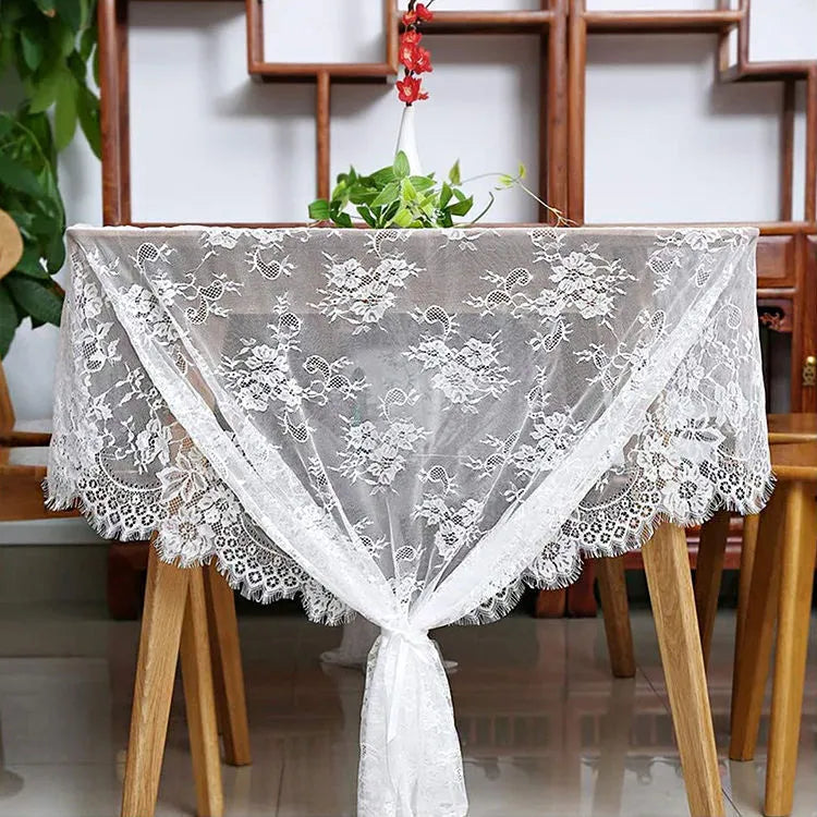 White embroidered lace tablecloth made from nylon yarn, 150x300cm, laid flat on a table with decorative pattern visible.