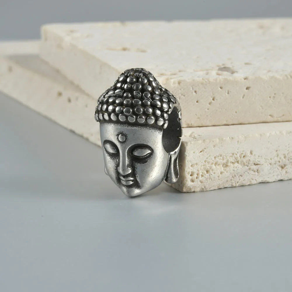 Stainless steel hollow skull and Buddha geometric design earrings in hip-hop style.