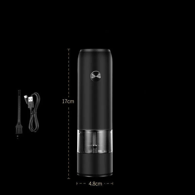 Black and silver electric pepper and salt grinder set with clear acrylic body on a kitchen counter.