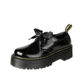 Women's white and black thick soled lace-up shoes with ribbon cross-straps on a superfine fibre upper.