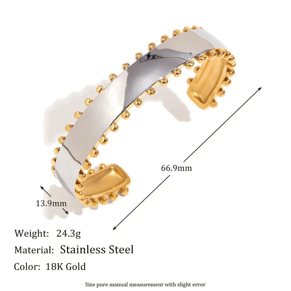 Gold-colour women's jewellery set with geometric earrings, round ring necklace, and matching bracelet on a grey background.