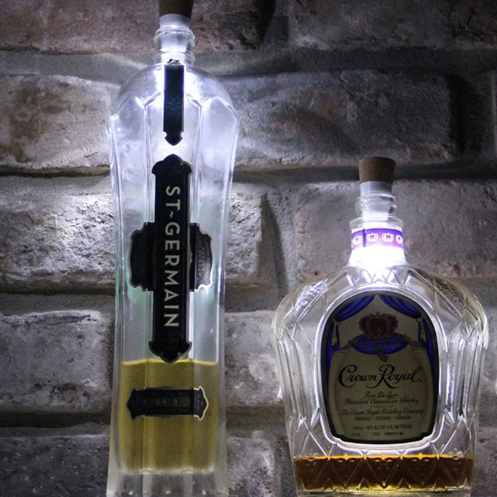 White plastic rechargeable LED bottle cap light with 15 small LEDs, shown next to a wine bottle for scale.