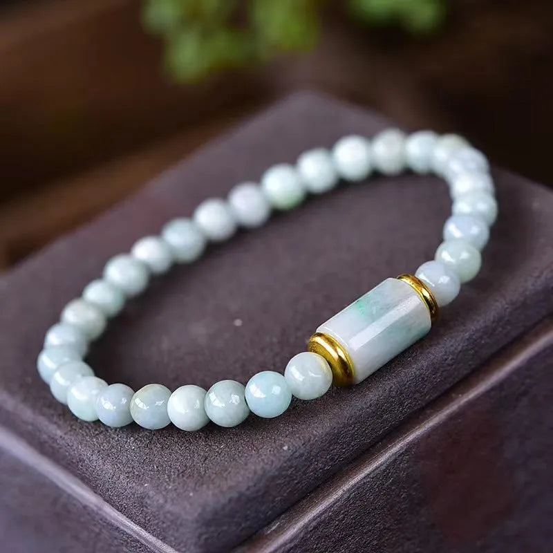 A close-up of a round Myanmar ice jade bead bracelet in emerald colour.