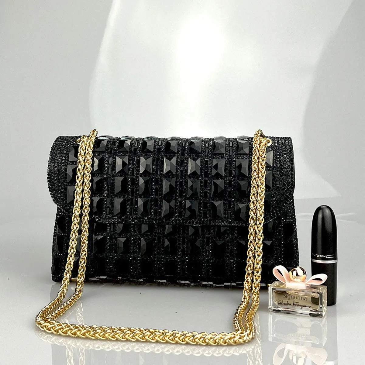 Silver rhinestone chain clutch purse with a horizontal square shape and open pocket.