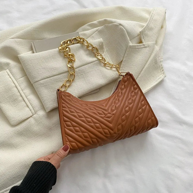 Brown vertical PU leather shoulder bag with a silver pleated chain strap and a soft handle.