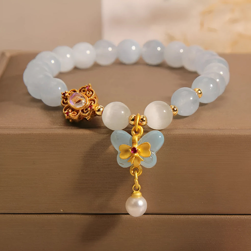 Women's crystal bracelet with aquamarine butterfly pendant and rhinestone details
