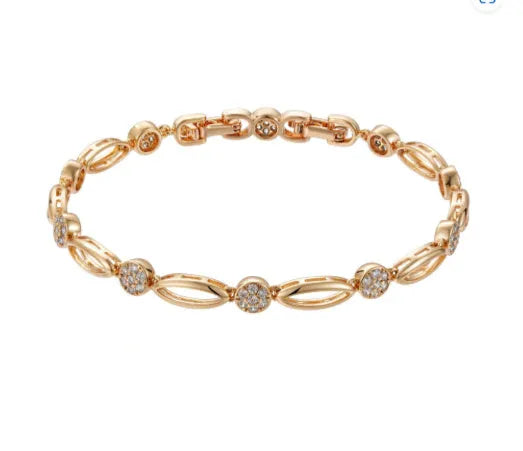 Golden coloured hollow carved copper bracelet with a U-shaped bangle profile on a white background.