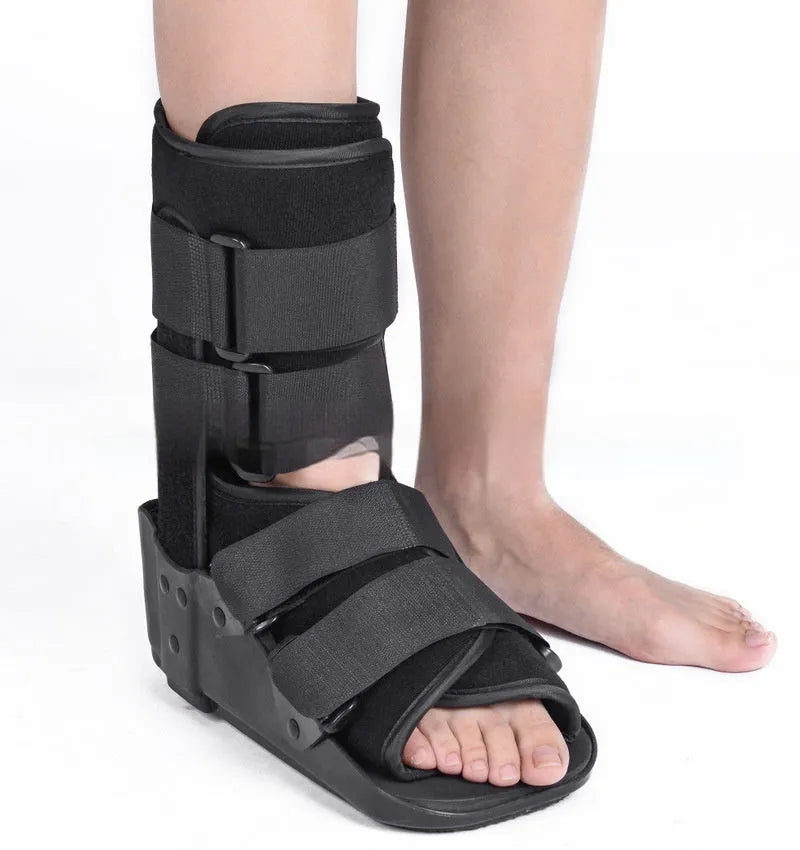 Grey Achilles tendon rehabilitation boot with fixed support and walking shoe sole.