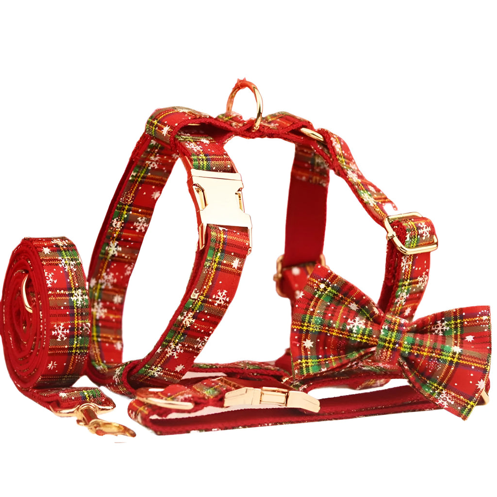Four-piece Christmas pet accessory set with red snowflake collar, plaid leash, festive vest, and bow tie