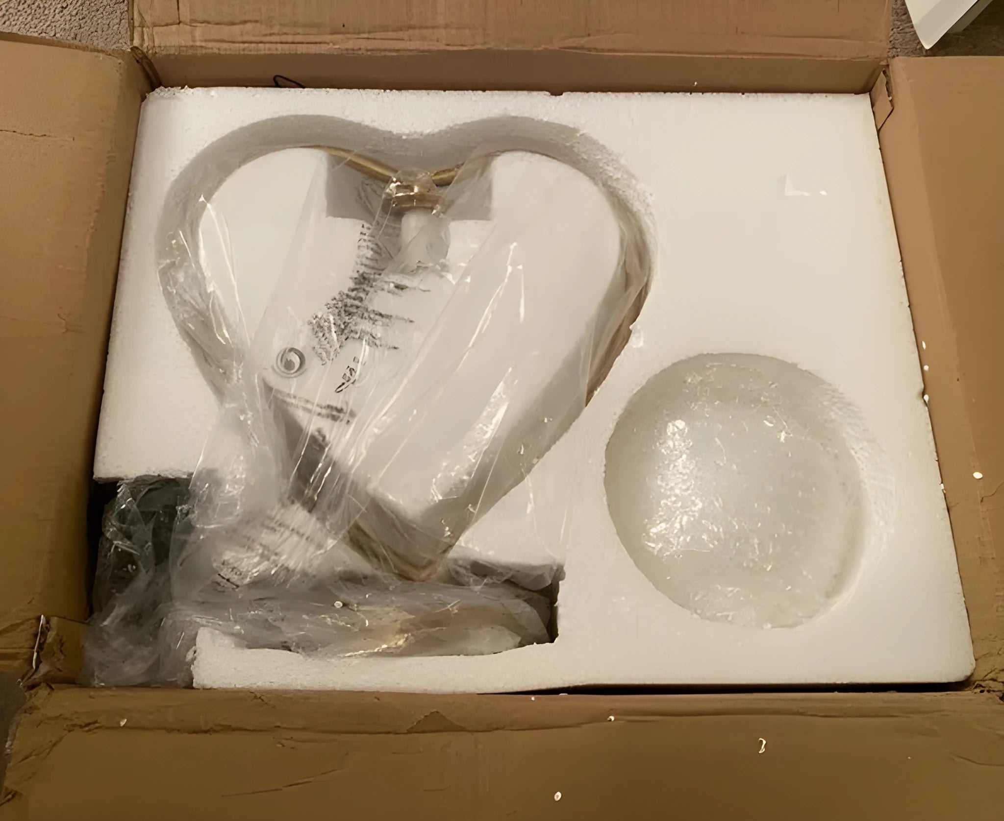 Tall white heart shaped LED table lamp on a wooden surface.