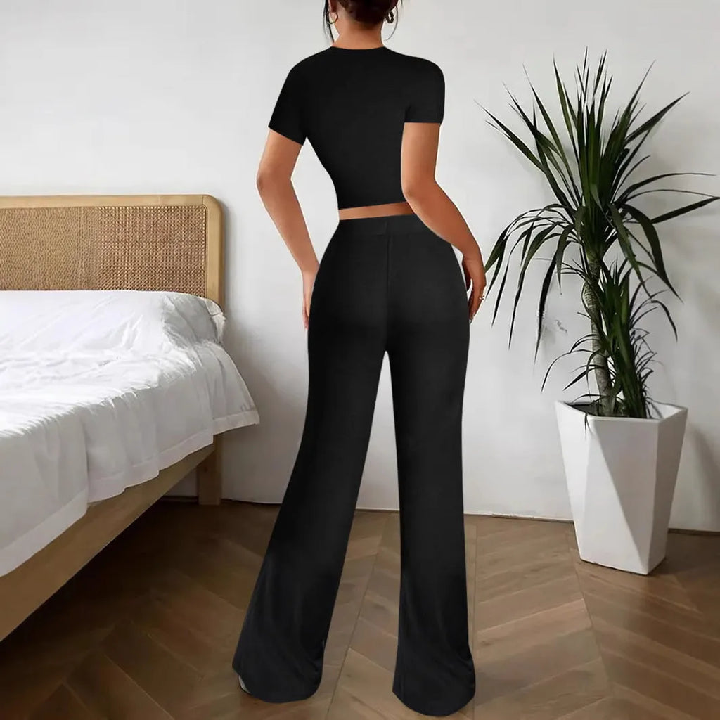Black polyester two‑piece co‑ordination set with high‑waist trousers and a short‑sleeve t‑shirt.