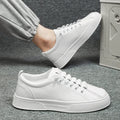 Men's black and white low top sports shoes with mesh panels and synthetic leather upper on a flat PVC sole.