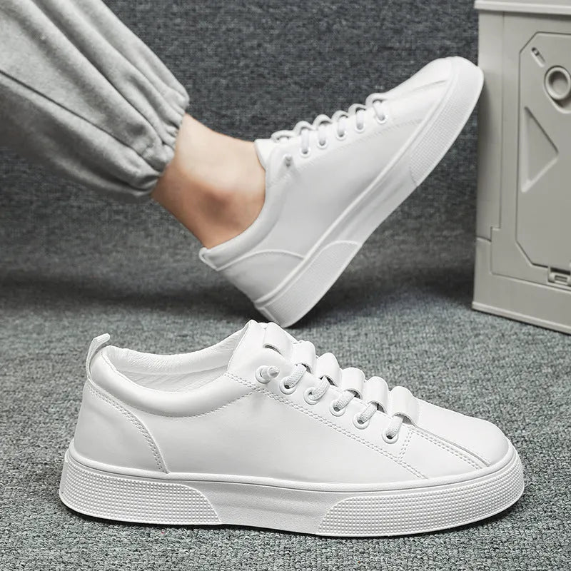 Men's black and white low top sports shoes with mesh panels and synthetic leather upper on a flat PVC sole.