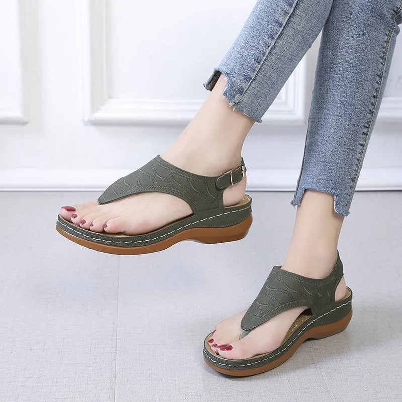 Women's black casual wedge heel sandals with an adjustable back strap buckle.