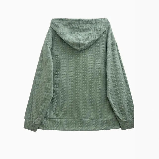 Green women's loose hooded zip-up coat on a hanger, showing front zipper and long sleeves.