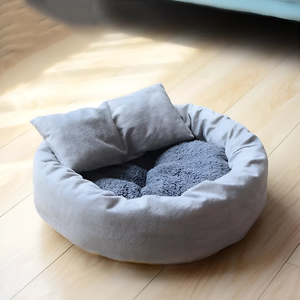 Grey round plush pet bed with a raised rim and non-slip base for small dogs and cats.