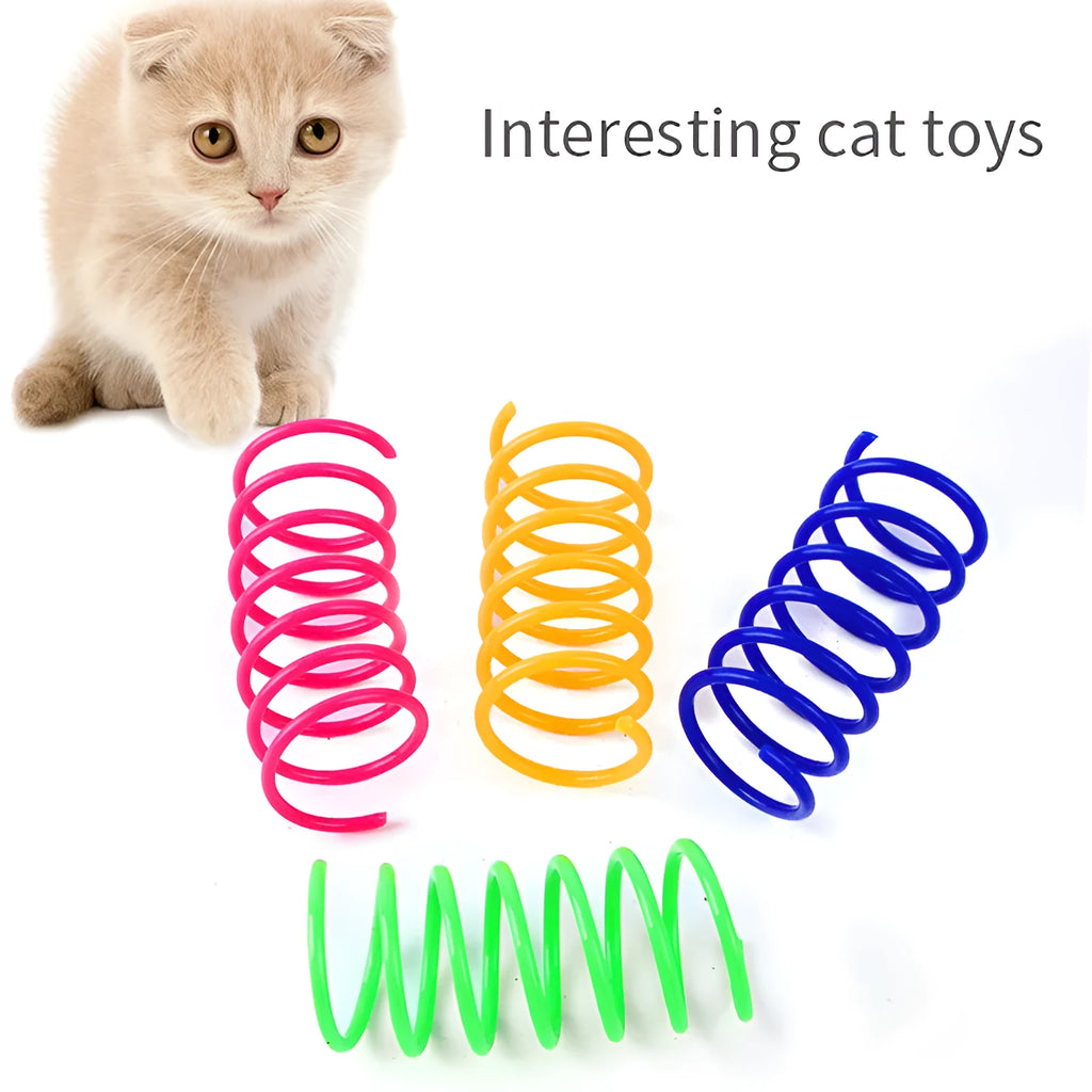 Colourful plastic coil spring toys for cats on a wooden floor.