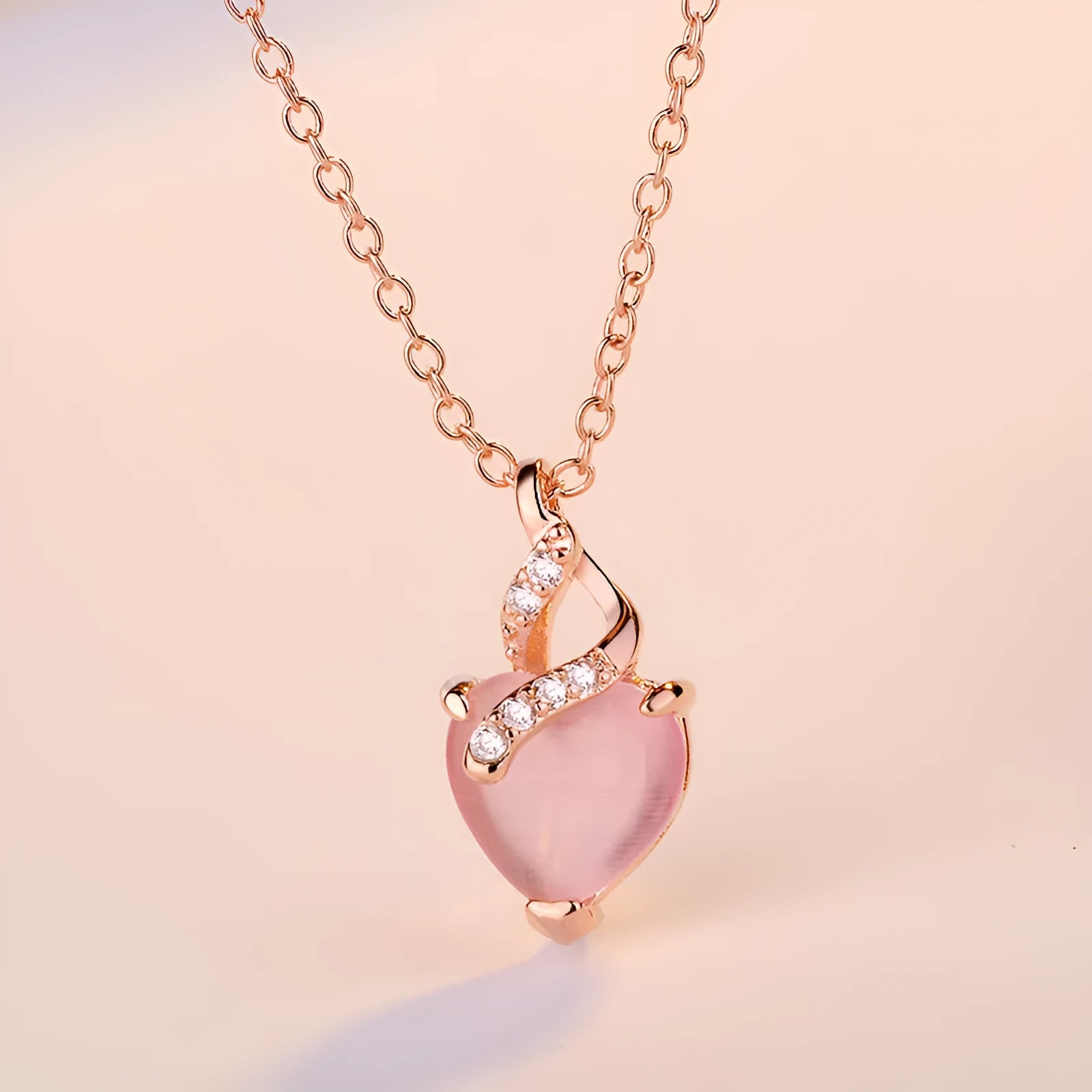 Heart-shaped pink crystal pendant necklace with rose gold cross chain for women