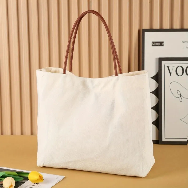 Beige white canvas tote bag with long handles and a front view showing its structured shape
