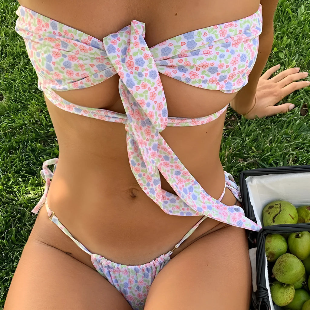 Women's blue printed swimsuit with front lace-up detail, split-leg briefs cut, and removable chest padding.