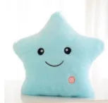 Colourful glowing five-pointed star plush pillow on a dark background, showing soft texture and LED illumination