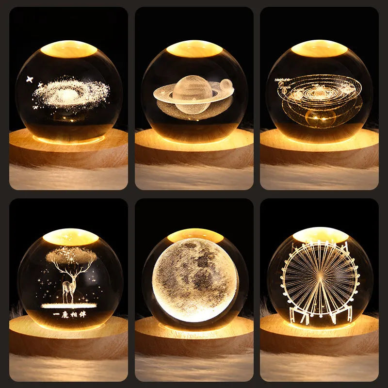 Clear crystal ball LED night light showing a 3D galaxy or planet design, lit from within on a table.