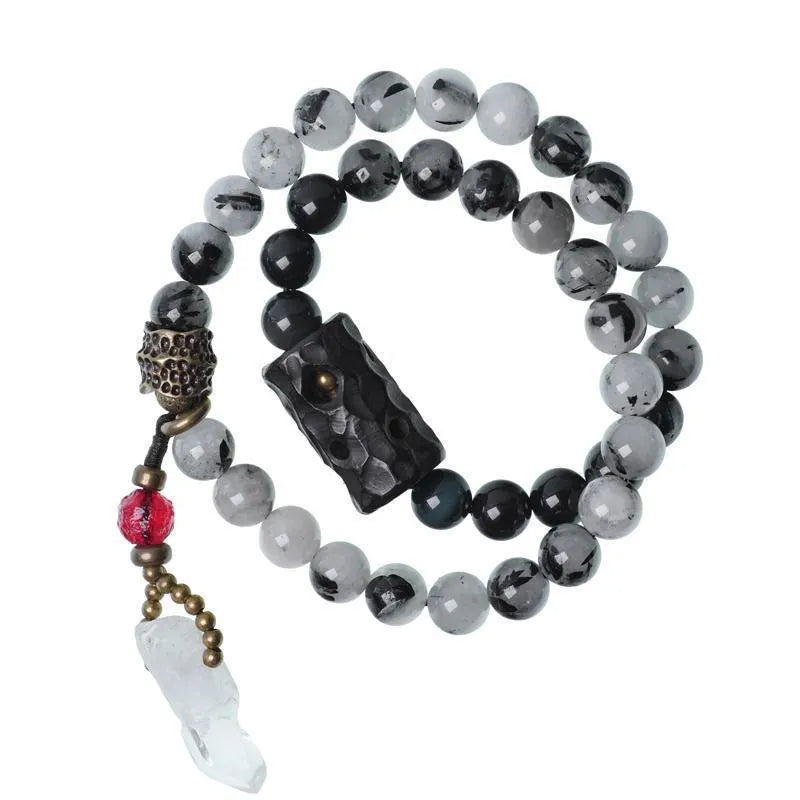 Ethnic black hair bracelet with white crystal tassel, shown in boys and girls size options.