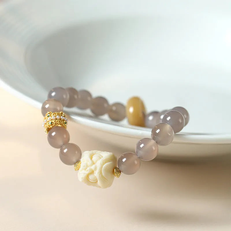 Hand-woven grey agate bracelet with ivory and mellite beads in a millet grain pattern