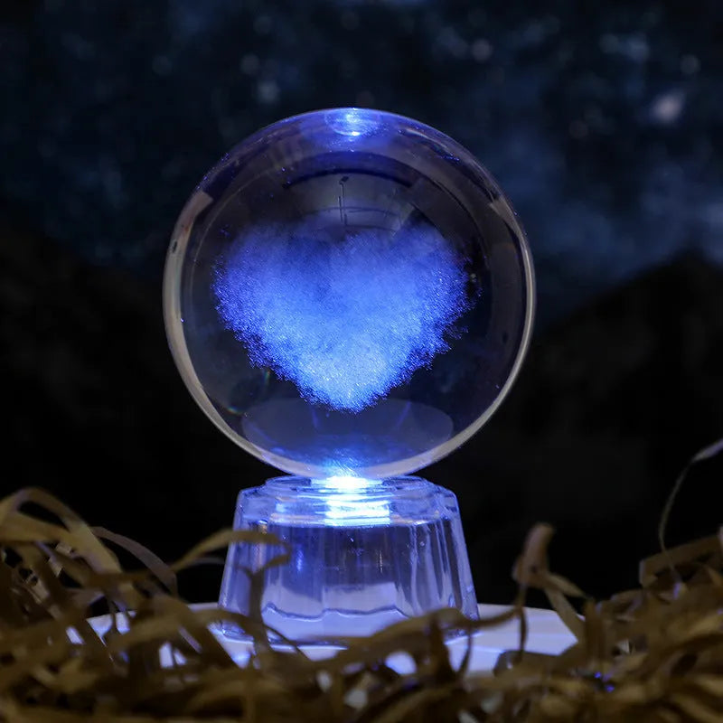 Transparent 6cm crystal ball ornament with inner carving on a fixed base, modern minimalist decor.