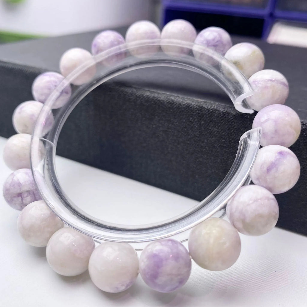 Close-up of a natural purple turquoise beaded bracelet with an adjustable string fastening.
