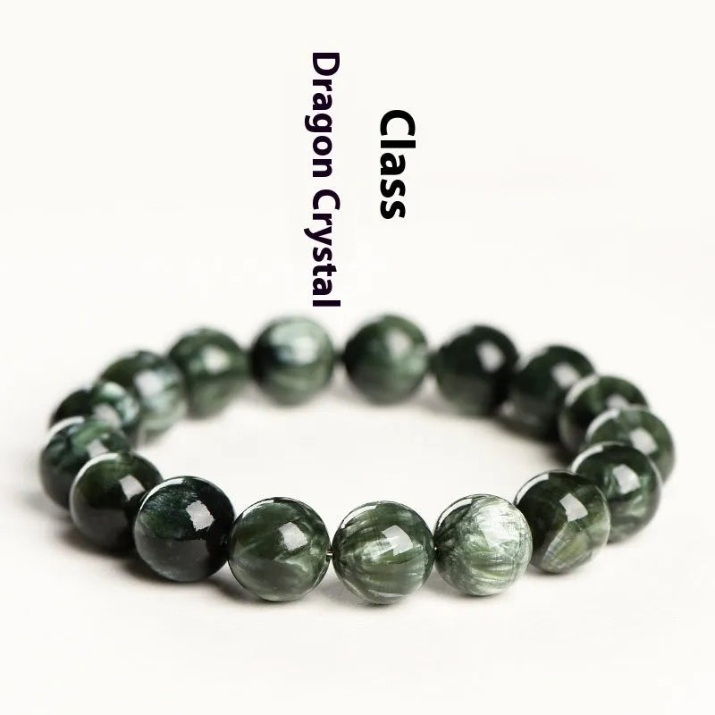 Natural green dragon crystal bead bracelet with geometric ruyi pattern on white background.